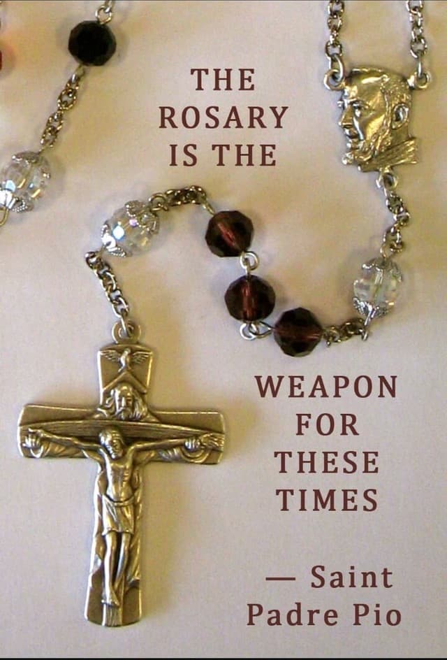 A rosary and crucifix with the words: The Rosary is the weapon for these times — Saint Padre Pio.